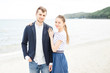 © ilya_oreshkov - European couple relaxing on the sea beach hugging each other and talking