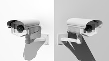 Two Security Surveillance Cameras On White Wall Corner
