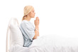 © Ljupco Smokovski - Female patient lying in a hospital bed and praying