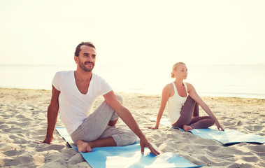 Canvas Print - couple making yoga exercises outdoors