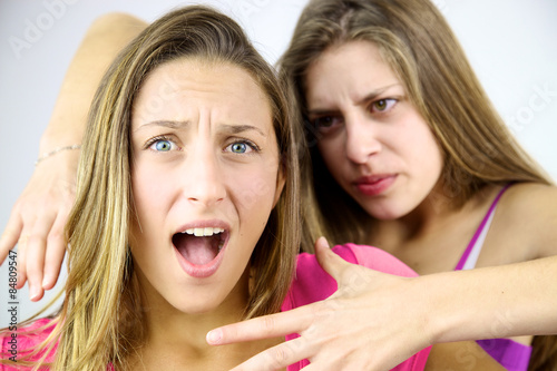 Fotografie, Obraz Angry girl willing to strangle blond screaming friend