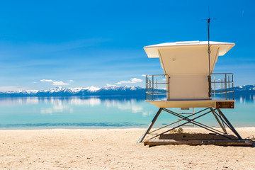 Canvas Print - Lake beach with lifeguard patrol station.