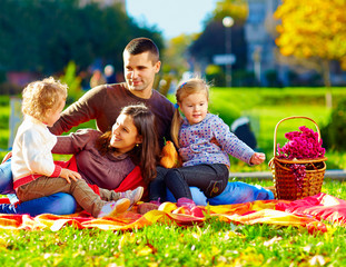 Wall Mural - happy family on autumn picnic in park