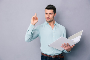 Poster - Man holding folder and pointing finger up