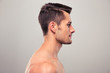 © Drobot Dean - Side view portrait of a young man with nude torso