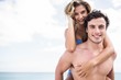 © WavebreakmediaMicro - Handsome man giving piggy back to his girlfriend