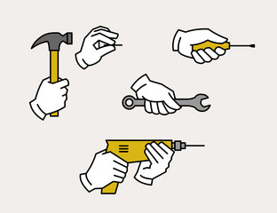 Hand holding drill, spanner, screwdriver, hammer and nail. Hardware tools.