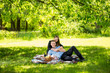 © Кирилл Рыжов - Beautiful couple in love relaxing under tree at park