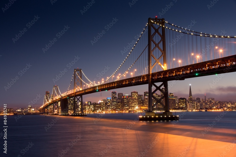 Dusk over San Francisco-Oakland Bay Bridge and San Francisco Skyline. Yerba Buena Island, San Francisco, California, USA. - obrazy, fototapety, plakaty 