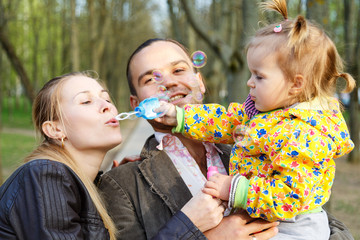 Happy parents with daughter outdoor