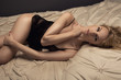 © nowicki - Sensual blonde woman posing in dark sexy lingerie.