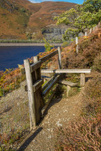 Wooden  Stile Style, Over Fence, With Bracken. Lake And Mountain