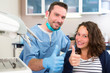 © Production Perig - Young attractive dentist explaning his work to a patient