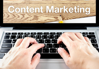 Poster - hand type on laptop with content Marketing word with blur backgr