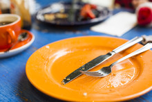 Empty Plate With Knife And Fork Showing A Finished Meal