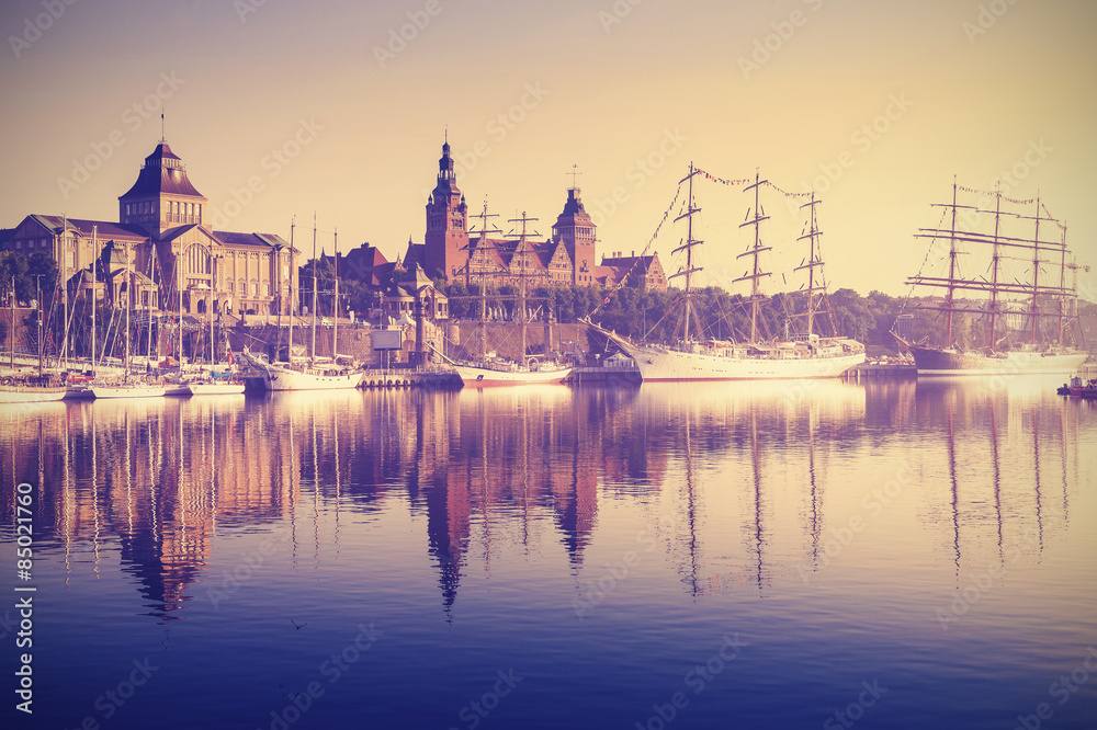 Vintage style picture of sailing ships in Szczecin at sunrise, Poland. - obrazy, fototapety, plakaty 