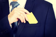 © Piotr Marcinski - Businessman taking a yellow card from pocket