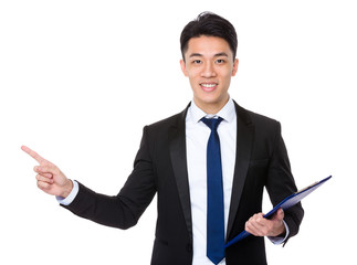 Young businessman holding with clipboard and finger showing up