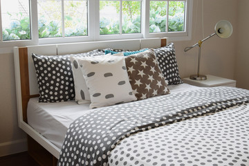 bedroom interior design with polka dot pillows on bed and decora