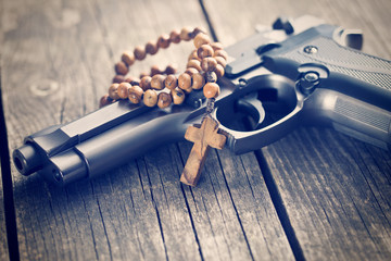 Wall Mural - rosary beads and gun