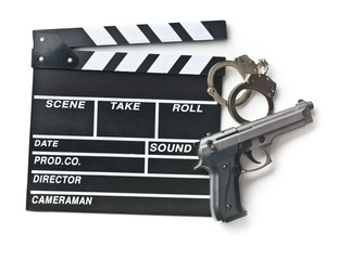 movie clapper and gun with handcuffs