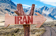 Iran wooden sign with desert road background