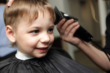 Smiling child at the barbershop