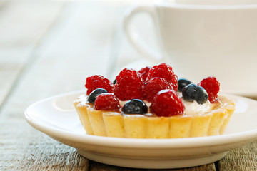 Wall Mural - Cake with berries and cup of coffee