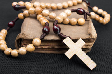 Wall Mural - rosary and prayer book on a dark background