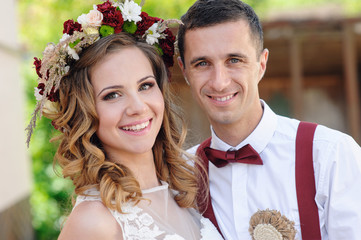 Wall Mural - happy beautiful bride and groom walking in sunlight