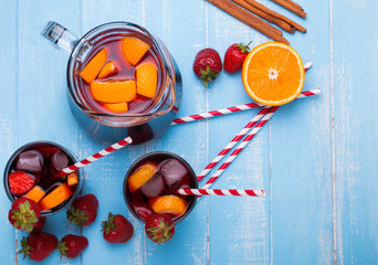 Wall Mural - Strawberry sangria on blue colored wooden background,