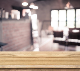 Poster - Empty wood table and blurred cafe light background. product disp