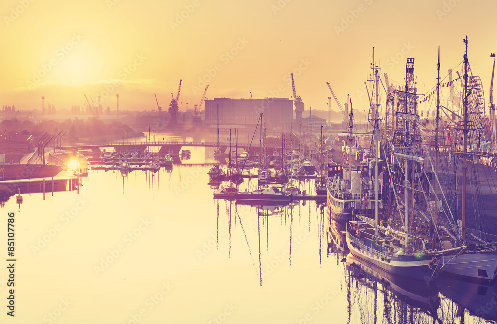 Vintage toned beautiful sunrise over harbor in Szczecin, Poland. - obrazy, fototapety, plakaty 