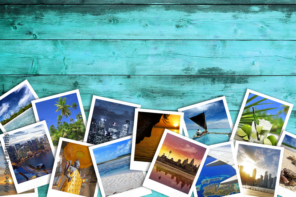 heap of travel photos on azure wood background - obrazy, fototapety, plakaty 