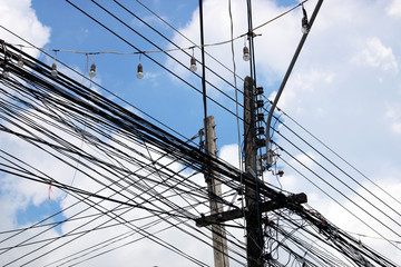 Abundance of Power Lines Connected to Wooden Poles