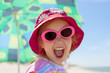 © izuboky - child girl happy smile healthy teeth sun glasses beach summer vacations