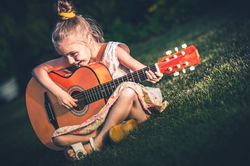 Wall Mural - Little Girl Playing Guitar