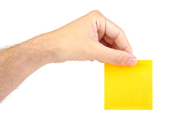 Hand holding one yellow notepaper or post it isolated on a white