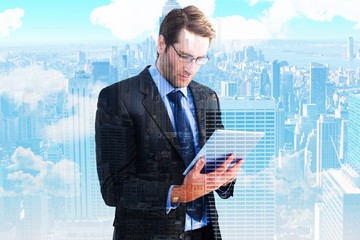Poster - Composite image of businessman using a tablet computer