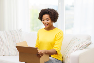 Sticker - happy african young woman with parcel box at home