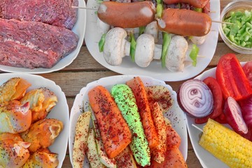 Table With Different Cookout Food On Plates For BBQ Party