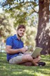 © WavebreakmediaMicro - hipster using laptop and phone in the park