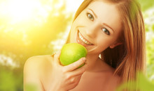 Beautiful Young Woman Eating Green Apple In The Summer On The Na