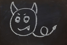 Smile Devil Face On Black Chalk Board