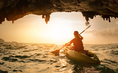 Young lady paddling the kayak