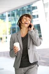 Wall Mural - Businesswoman walking and talking in the city