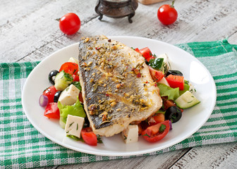 Wall Mural - Baked seabass with Greek salad. 