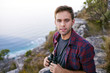 © marvent - Young guy looking at you while holding binoculars outdoors