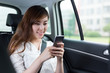 © zhu difeng - Beautiful asian young woman using mobile phone in car