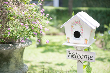 White bird house in the garden